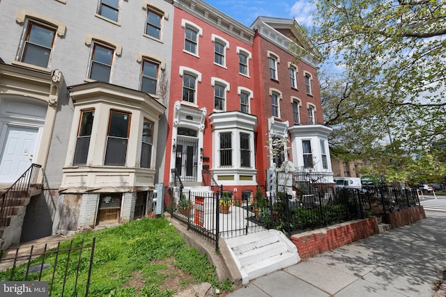 multi unit property featuring a fenced front yard