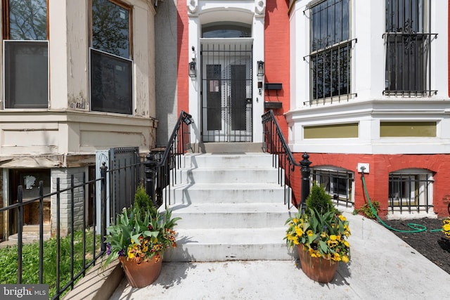 view of exterior entry featuring fence