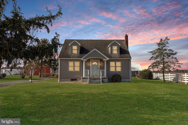 cape cod-style house with a yard