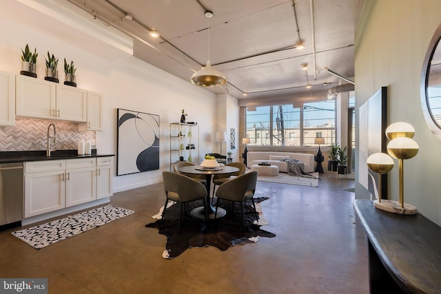 dining area featuring baseboards and concrete flooring