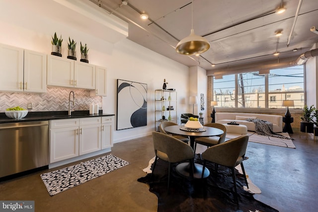 dining space with finished concrete floors and baseboards