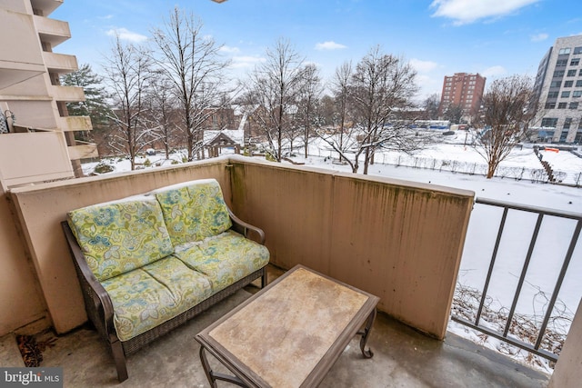 view of snow covered back of property