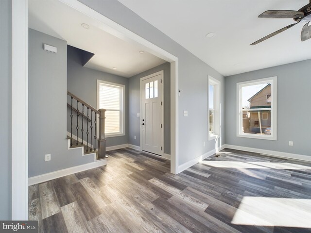 entrance foyer featuring stairs, ceiling fan, dark wood-style floors, and baseboards