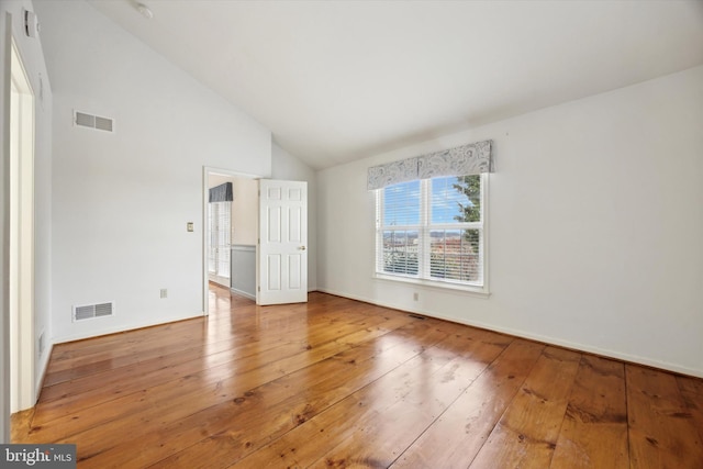 unfurnished bedroom featuring wood-type flooring and high vaulted ceiling