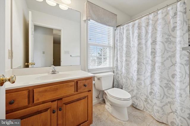 bathroom featuring vanity, tile patterned floors, and toilet