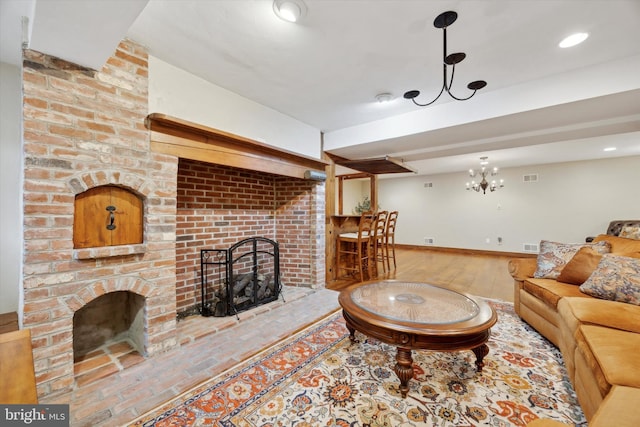 living room featuring wood-type flooring and a brick fireplace