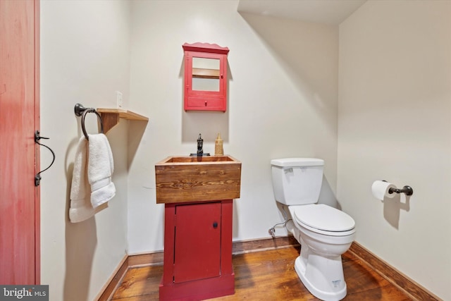 bathroom featuring hardwood / wood-style flooring, vanity, and toilet