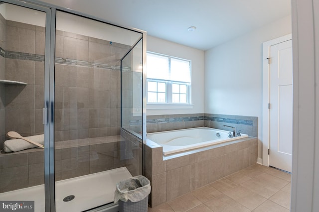 bathroom featuring plus walk in shower and tile patterned flooring