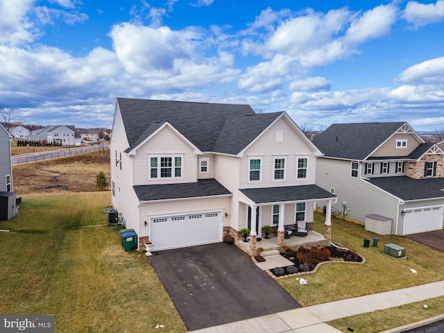 view of front of home with central air condition unit, a front lawn, a porch, and a garage