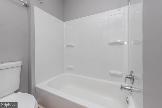 bathroom with bathtub / shower combination and toilet