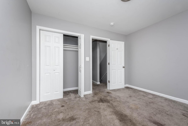 unfurnished bedroom featuring a closet and carpet