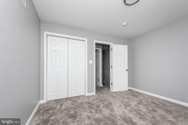 unfurnished bedroom with carpet floors and a closet