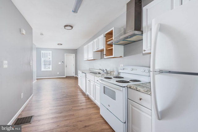 kitchen featuring sink, white appliances, light hardwood / wood-style floors, white cabinets, and wall chimney exhaust hood