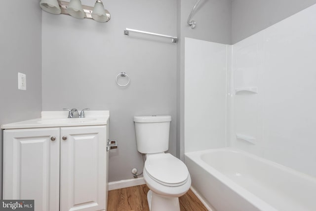 full bathroom with vanity, hardwood / wood-style floors, toilet, and shower / bath combination