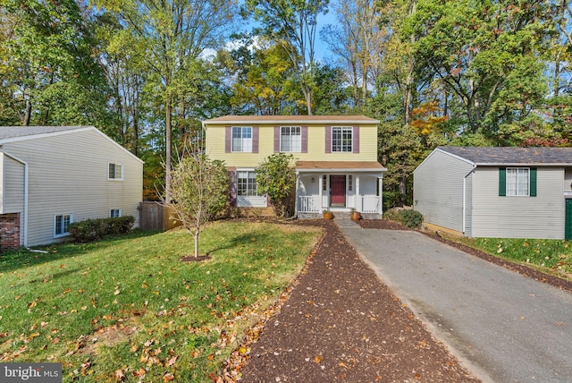 traditional home with a front lawn and a porch