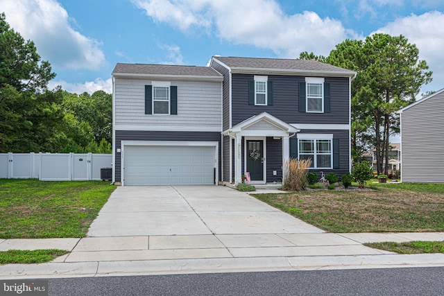 view of front of home with a garage, a front yard, and central air condition unit