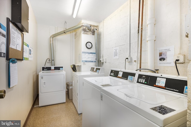 common laundry area featuring washer and dryer and light floors