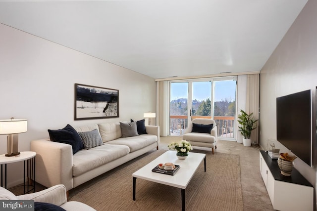 living area with light carpet and expansive windows