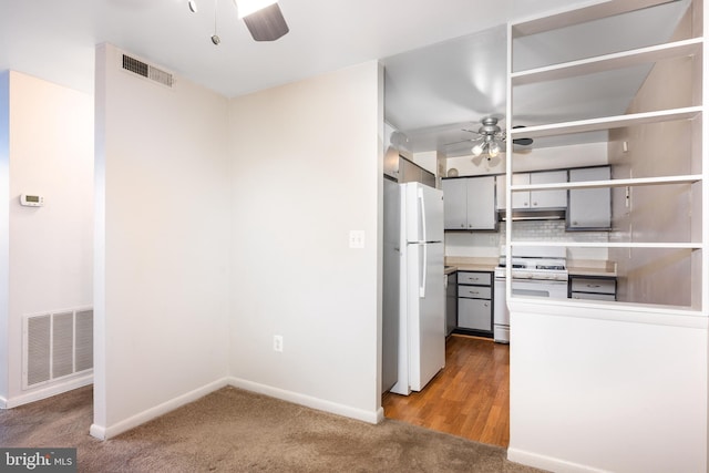 kitchen featuring ceiling fan, white appliances, gray cabinets, and visible vents