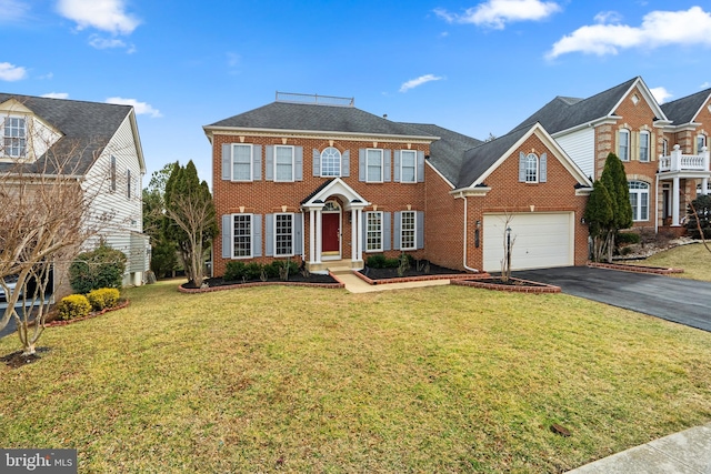 view of front facade featuring aphalt driveway, a front yard, brick siding, and a garage