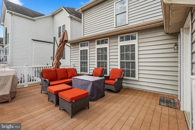 wooden deck with grilling area and an outdoor living space