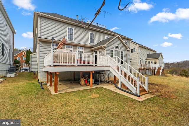 back of house with a patio, a lawn, central AC, a wooden deck, and stairs