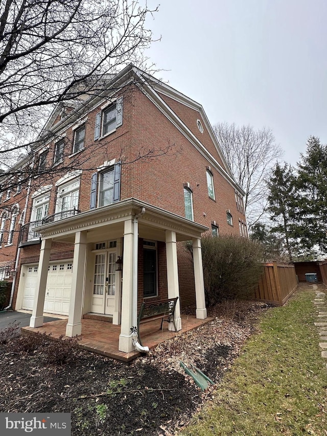 view of property exterior featuring a porch and a garage