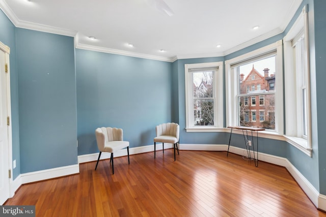 living area featuring ornamental molding and hardwood / wood-style floors