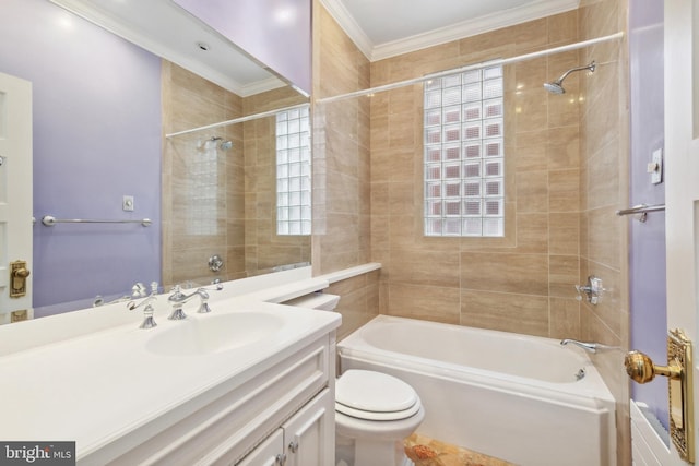 full bathroom with tiled shower / bath combo, crown molding, vanity, and toilet