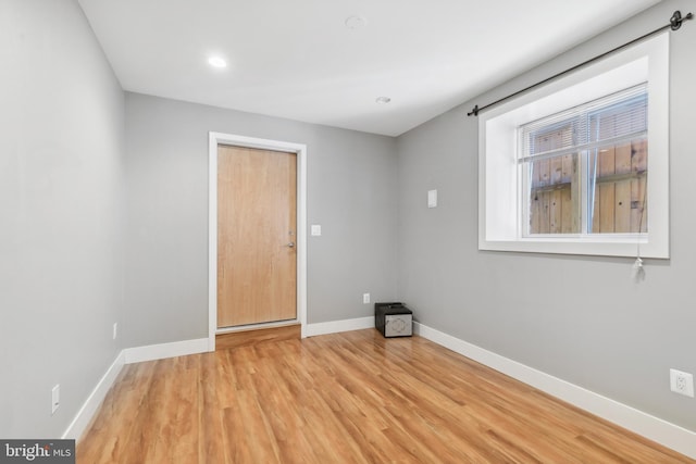 spare room with light hardwood / wood-style flooring