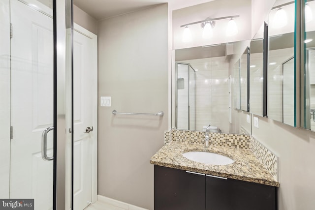 bathroom with vanity and a shower with door