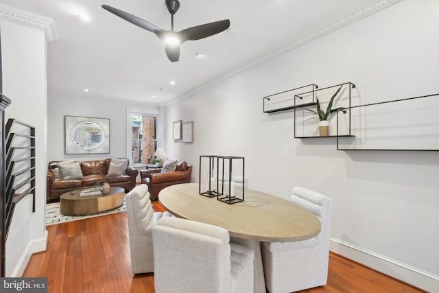 dining area with ornamental molding, hardwood / wood-style flooring, and ceiling fan