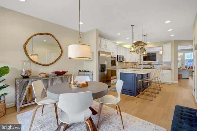 dining area featuring light hardwood / wood-style flooring and sink