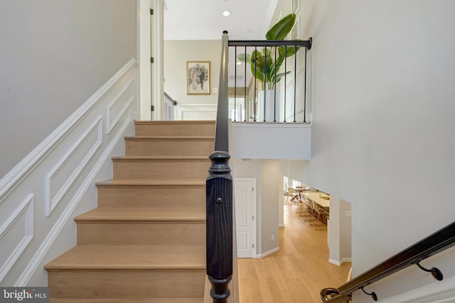 stairs featuring hardwood / wood-style flooring