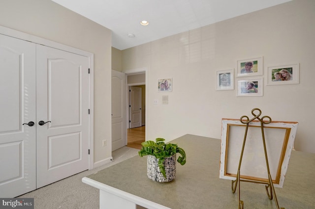 sitting room featuring light colored carpet