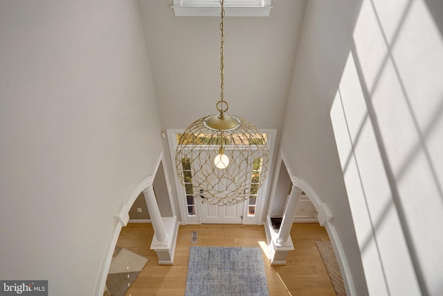 entryway featuring a high ceiling and light hardwood / wood-style floors