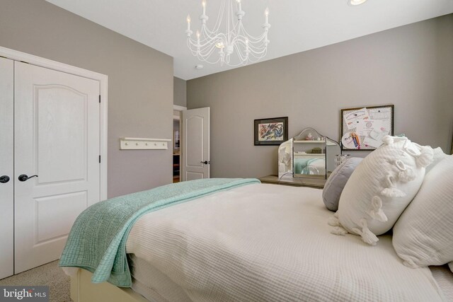 bedroom featuring a closet and a notable chandelier