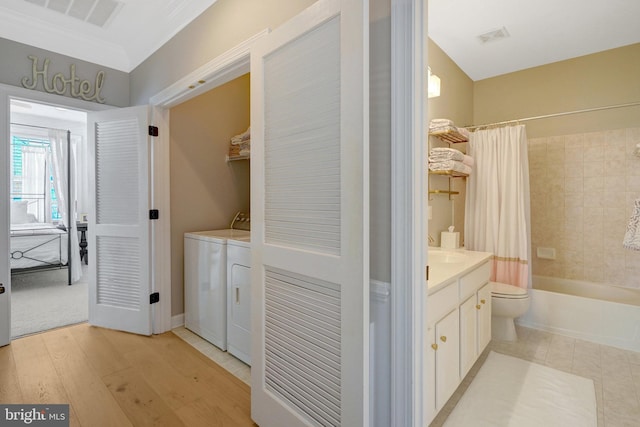 washroom featuring sink, independent washer and dryer, and light hardwood / wood-style floors