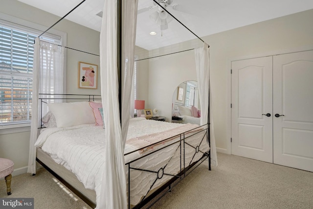 bedroom with a closet and light colored carpet