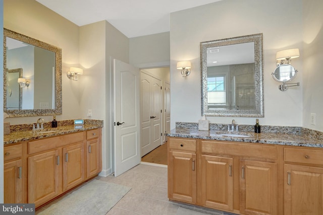 bathroom with tile patterned flooring and vanity