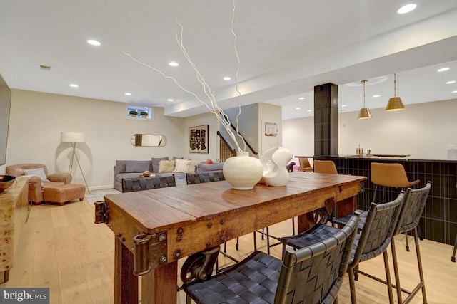 dining space with light hardwood / wood-style flooring