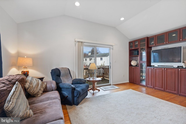 living room with lofted ceiling and light wood-type flooring