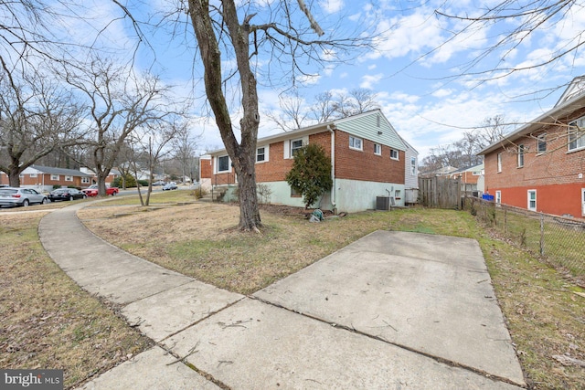 view of home's exterior featuring a yard, central AC, and a patio