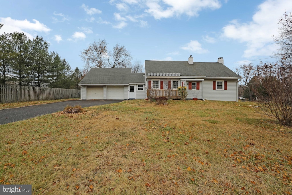 view of front of property with a garage and a front yard