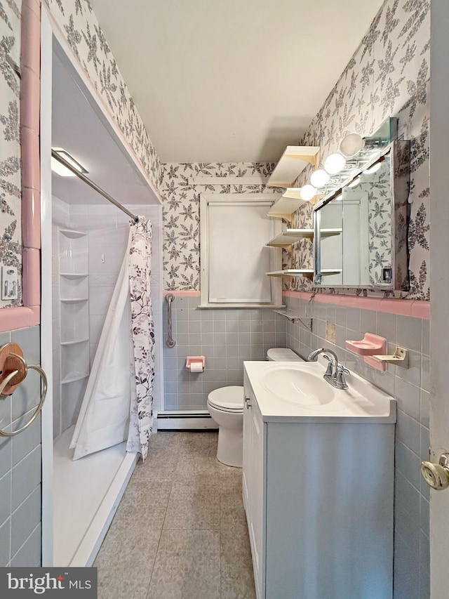 bathroom featuring walk in shower, toilet, tile walls, a baseboard radiator, and vanity