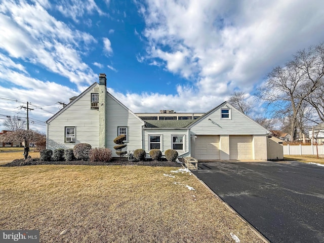 view of front of property with a garage and a front lawn