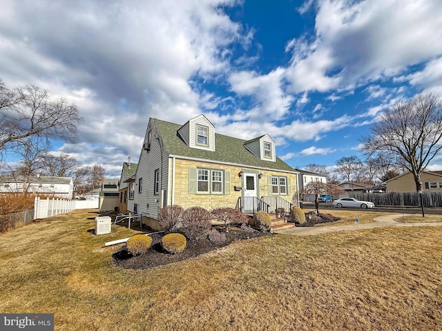 new england style home featuring a front yard