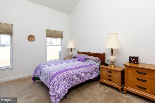 carpeted bedroom with vaulted ceiling