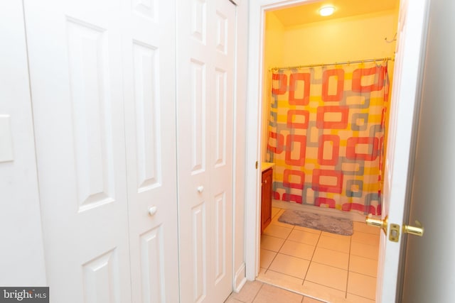 hall with light tile patterned floors