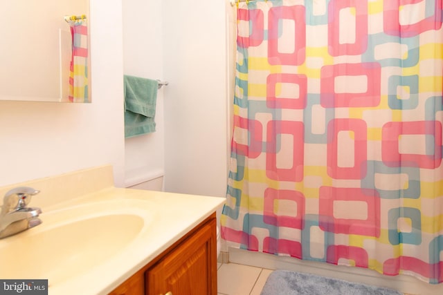 bathroom featuring vanity, tile patterned floors, and walk in shower